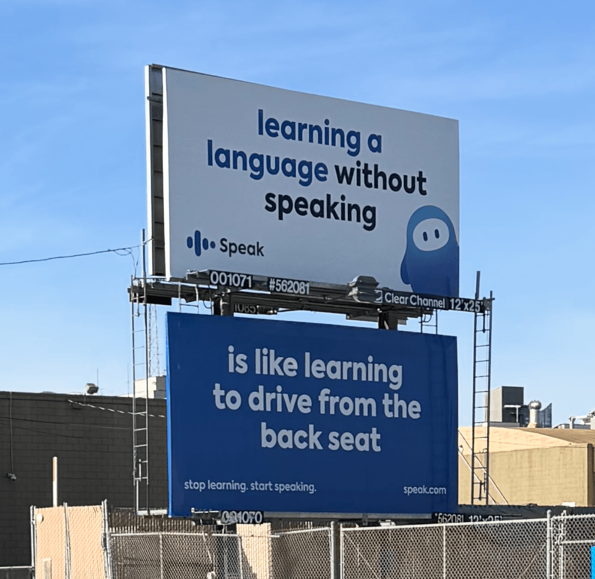 A Speak billboard comparing learning a language without speaking to learning to drive from the back seat